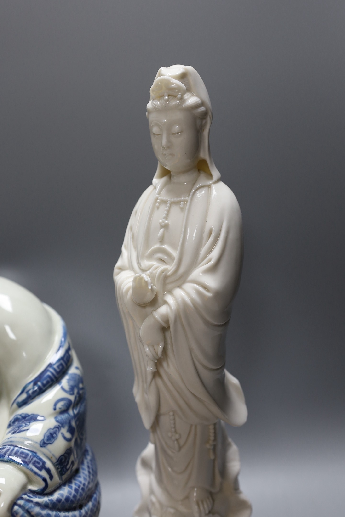 A Chinese peach vase, Buddha, two hardstone balls and a blanc de chine figure and a bowl and cover on stand, peach vase 32 cms high